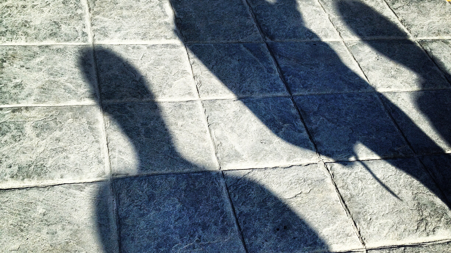 Photo of people shadows on paving stones