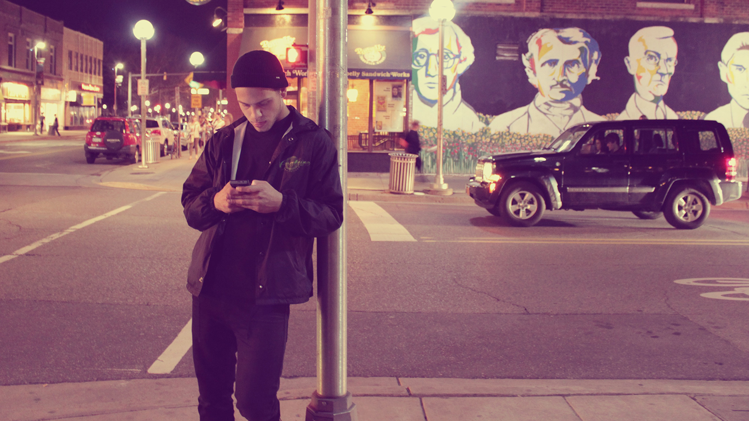 Young guy texting on the street