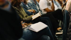 Photo of people sitting with pads on laps by Nicole Honeywill on Unsplash